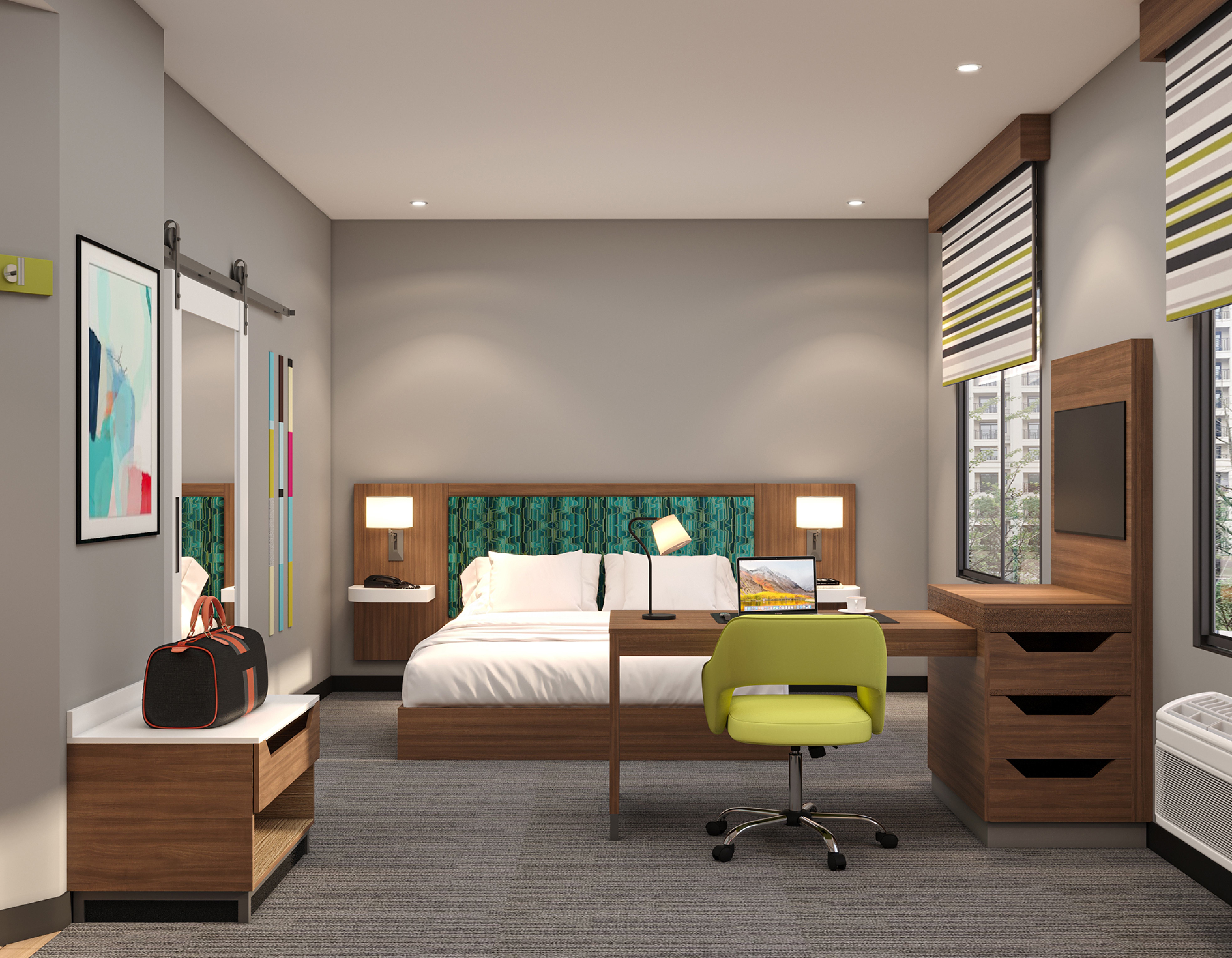 Guest room desk and seating area with green accent chair